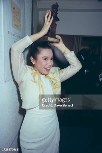 Filipina singer and actress Lea Salonga holds her Laurence Olivier Award for Best Actress in a Musical for her role as 'Kim' in Miss Saigon, London,...