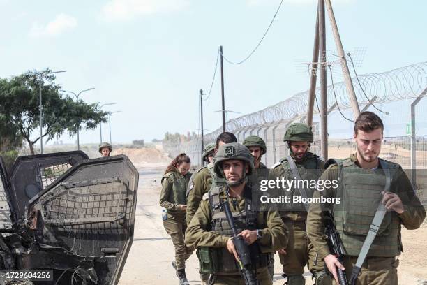 Israeli defense force soldiers on patrol beside the Gaza border security fence following fighting between Israeli soldiers and Hamas militants near...