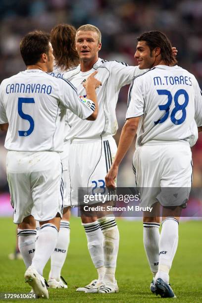 David Beckham talks with Fabio Cannavaro and Miguel Torres of Real Madrid during the LaLiga Match between Real Madrid v Deportiva La Coruna at the...