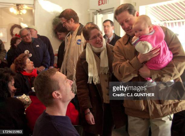 Vice President and Democratic Presidential Hopeful Al Gore holds six-month-old Gabrielle Proska as her father Robert Proska and Sarah Gore look on at...