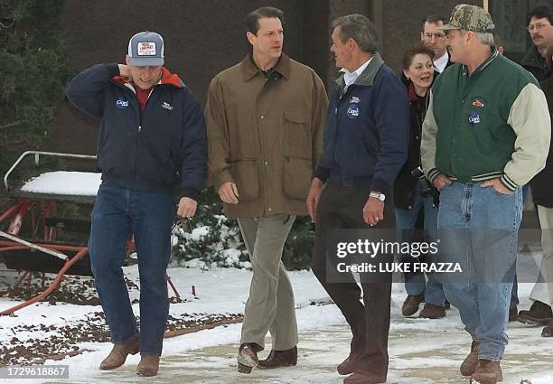 Democratic presidential hopeful US Vice President Al Gore walks with family farmers on the Menz family farm 21 January 2000 in Perry, Iowa. Gore is...