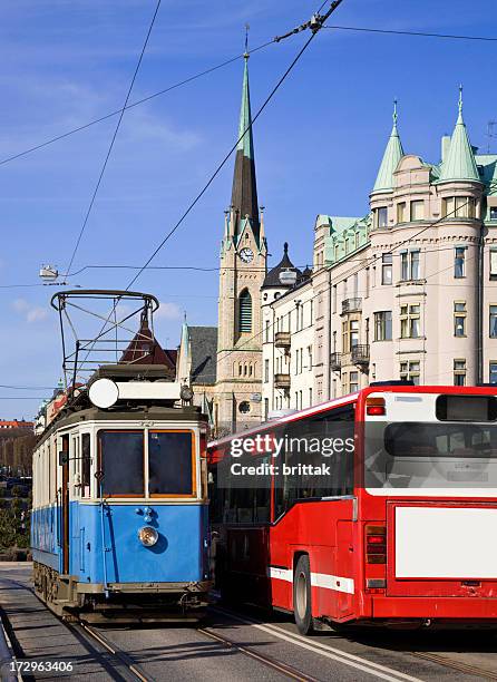 old blue tram meets red bus along strandvägen, stockholm - strandvägen stock pictures, royalty-free photos & images