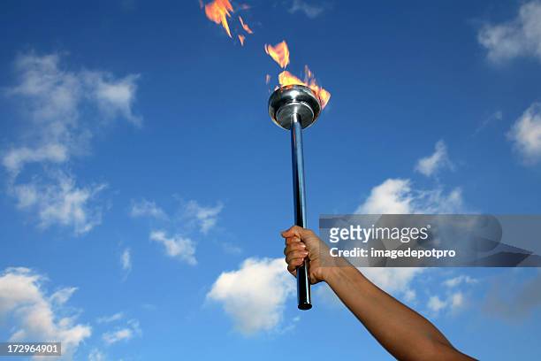 glory of holding flaming torch - the olympic games stock pictures, royalty-free photos & images