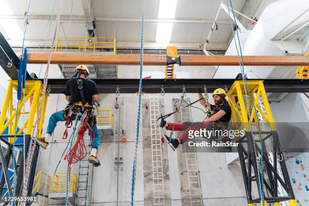 two workers doing climbing training - gateway high school stock pictures, royalty-free photos & images