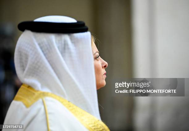 Italian Prime Minister Giorgia Meloni stands with Bahrain's King Hamad bin Isa Al Khalifa as they meet in Rome Palazzo Chigi on October 17, 2023.