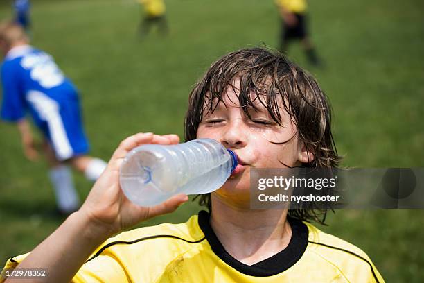 boy drinking water - drinking water outside stock pictures, royalty-free photos & images