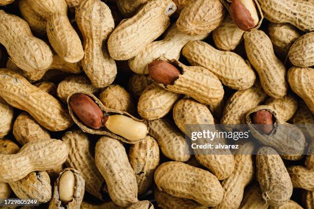 background of a large group of peanuts - peanuts stock pictures, royalty-free photos & images