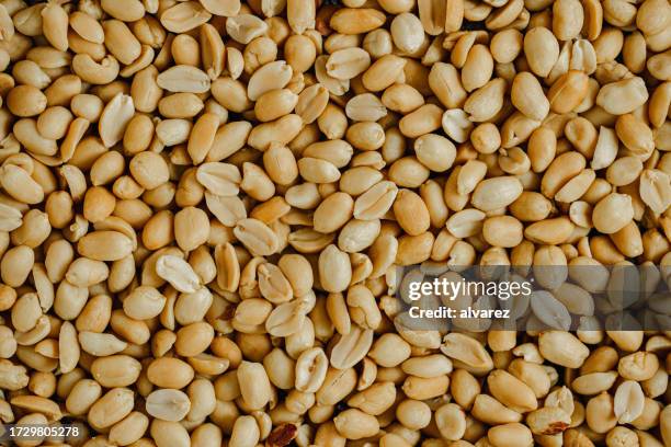 full frame of crunchy roasted peanuts - peanut food stock pictures, royalty-free photos & images