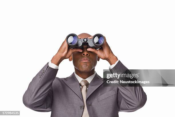 young businessman looking through binoculars - binoculars isolated stock pictures, royalty-free photos & images