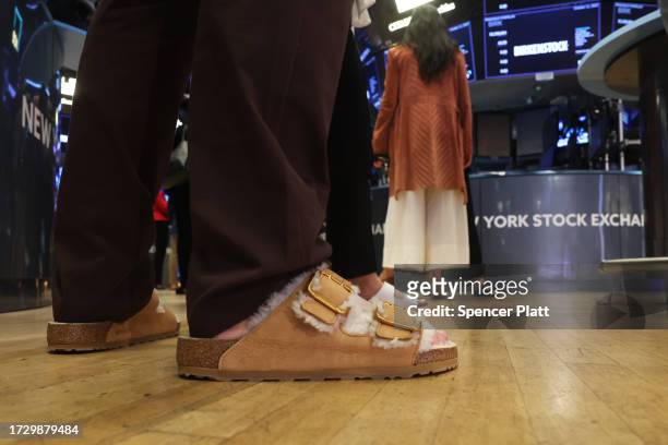 Traders wear Birkenstock sandals on the floor of the New York Stock Exchange as the German footwear company makes its debut on the Exchange on...
