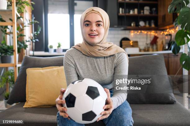 excited woman watching a soccer match on tv at home - finals game one stock pictures, royalty-free photos & images