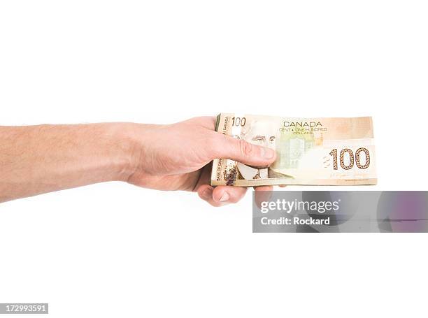 hand holding dollar bills against white background - canadese valuta stockfoto's en -beelden