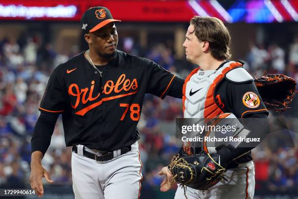 Yennier Cano and Adley Rutschman of the Baltimore Orioles walk back to the dugout after the eighth inning against the Texas Rangers during Game Three...