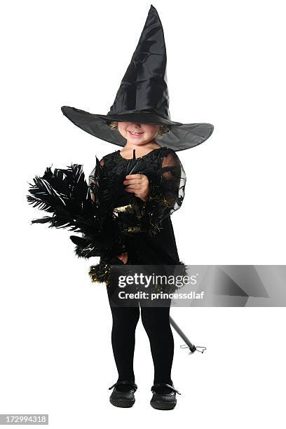a young girl dressed in black as a witch with hat and broom - fancy dress costume stock pictures, royalty-free photos & images