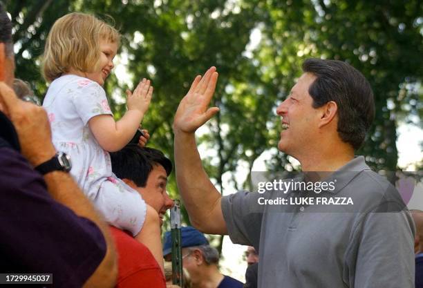 Vice President and Democratic presidential candidate Al Gore speaks with three-year-old Caroline Murray and her dad David Murray 24 July, 2000 in...