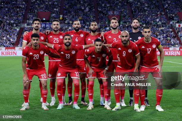 Tunisia's players pose for a photograph before the international friendly football match between Japan and Tunisa at Noevir Stadium in Kobe on...