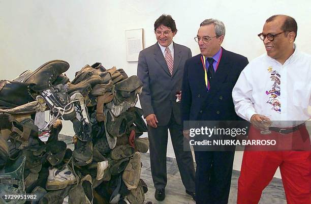 Vice President of Colombia Gustavo Bell Lemus next to Eusebio Leal , a historian, and curator Alvaro Barrios observe an art piece titled "Cupboard...