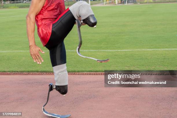 explosive start of athlete with handicap at the stadium - one-armed-person-handicapped-person stock pictures, royalty-free photos & images