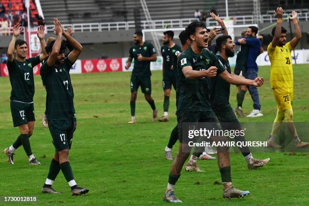 Pakistan's players celebrate their win at the 2026 FIFA World Cup qualifiers football match between Pakistan and Cambodia, at the Jinnah Sports...