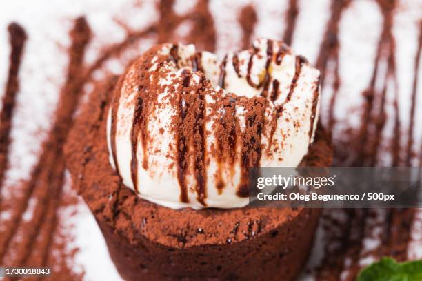 close-up of chocolate cake on table - whip cream dollop stock pictures, royalty-free photos & images