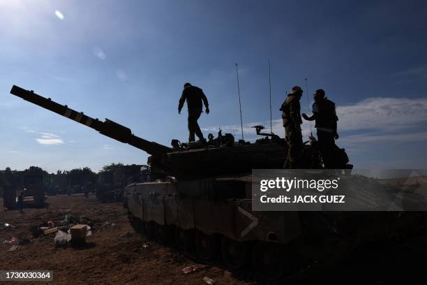 Israeli soldiers are positioned outside kibbutz Beeri near the border with the Gaza Strip on October 17 in the aftermath of an October 7 attack by...