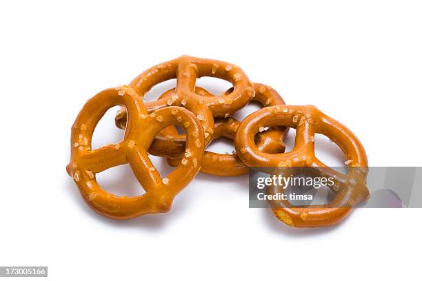 pretzels in a pile isolated on white - pretzel stockfoto's en -beelden