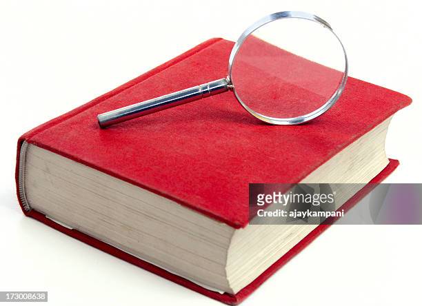 magnifying glass on a red book - vocabulary stock pictures, royalty-free photos & images