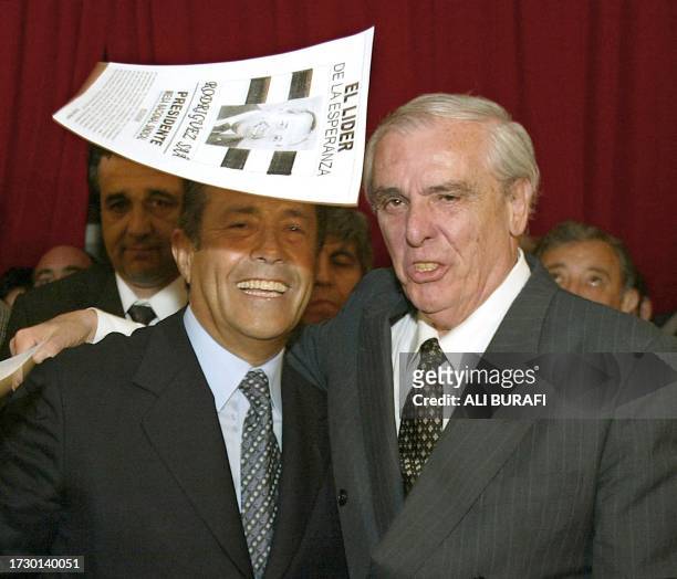An electoral flyer falls, 16 September 2002 in Buenos Aires, on the head of the Justicialista presidential candidate of Argentina for the elections...