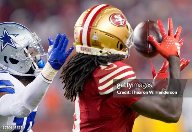 Brandon Aiyuk of the San Francisco 49ers catches a pass over Noah Igbinoghene of the Dallas Cowboys during the third quarter of an NFL football game...
