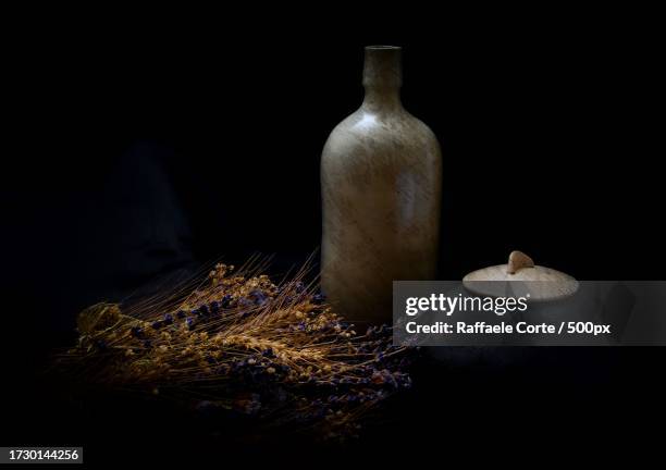 close-up of bottle against black background - raffaele corte stock pictures, royalty-free photos & images