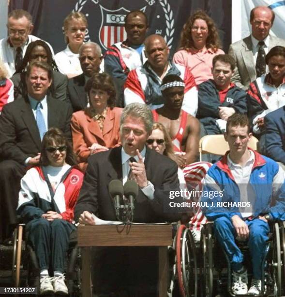 President Bill Clinton, joined by 30 former and current Olympians and Paralympians, delivers a speech 01 May to students at Eastern High School in...