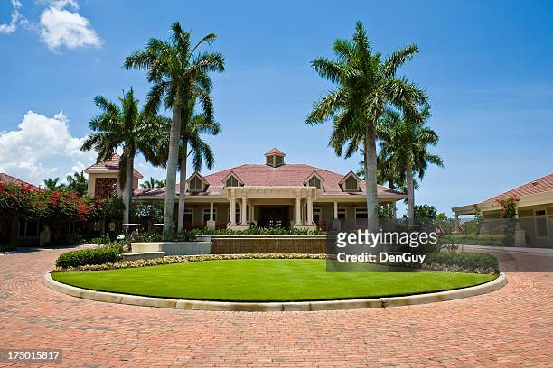 impressive clubhouse with brick driveway florida golf community wide angle - golf merchandise stock pictures, royalty-free photos & images
