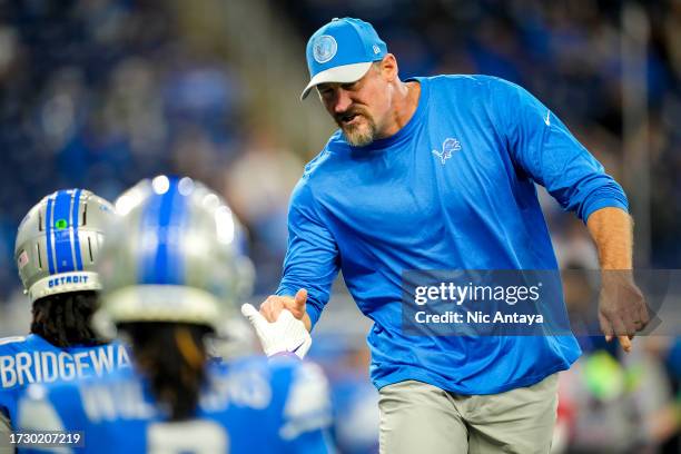 Head coach Dan Campbell of the Detroit Lions fist bumps Teddy Bridgewater of the Detroit Lions before the game against the Carolina Panthers at Ford...