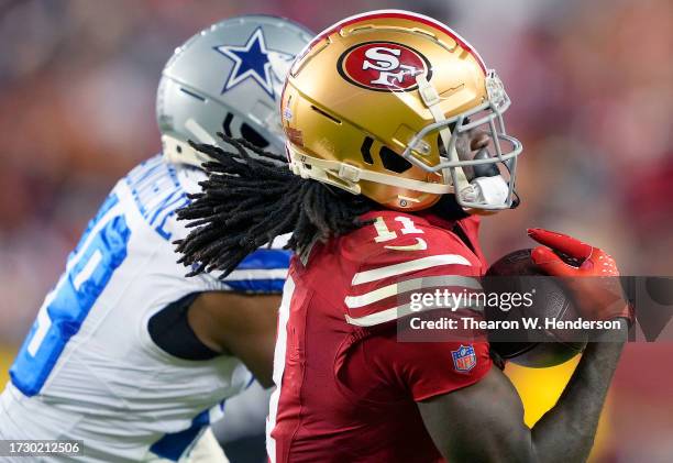 Brandon Aiyuk of the San Francisco 49ers catches a pass over Noah Igbinoghene of the Dallas Cowboys during the third quarter of an NFL football game...