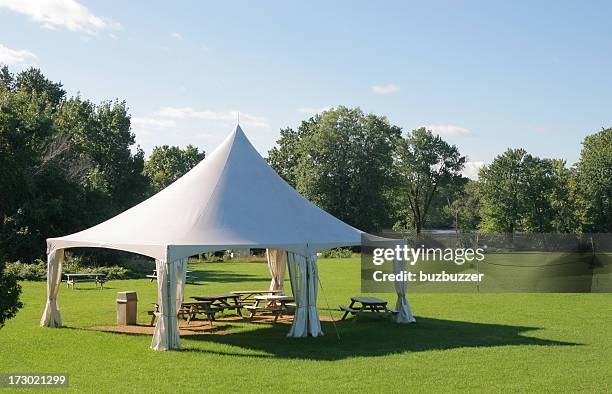 small marquee tent with picnic tables in a park - tent stock pictures, royalty-free photos & images