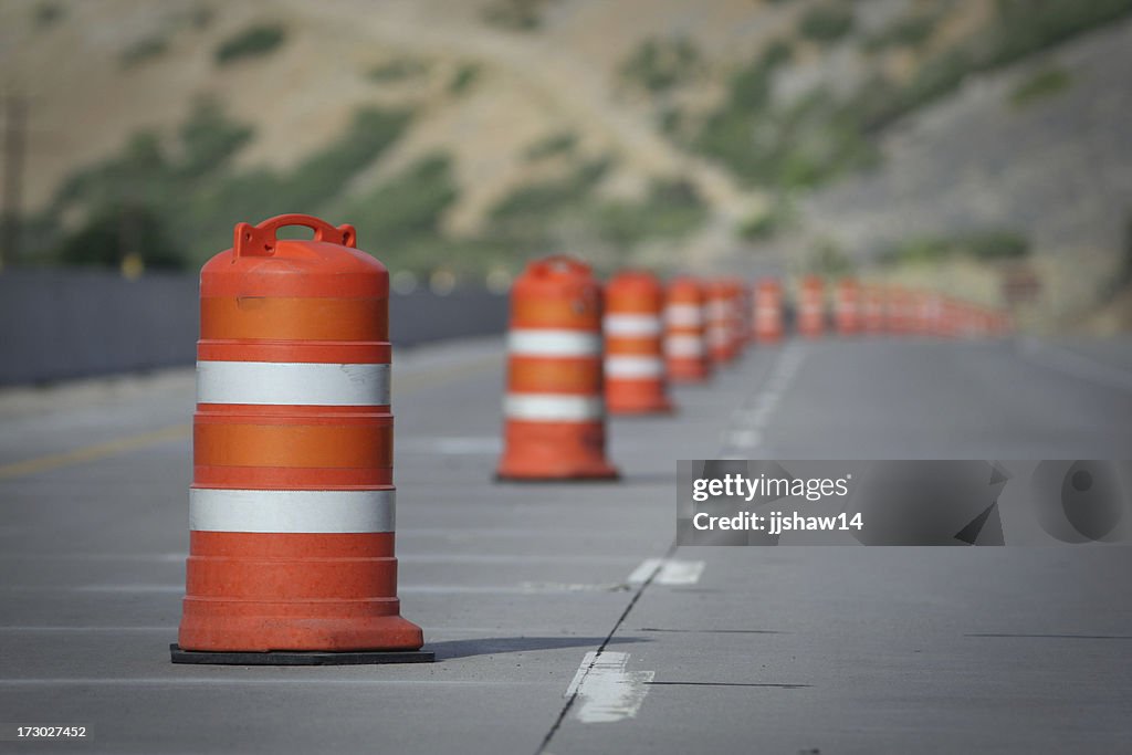 Orange and white construction cones closing a road Lane
