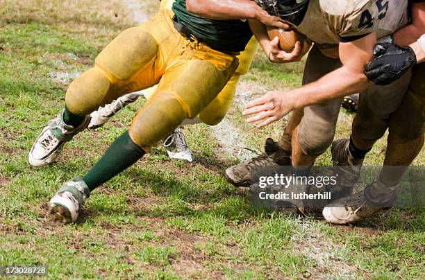 football running back being tackled - american football lineman stock pictures, royalty-free photos & images