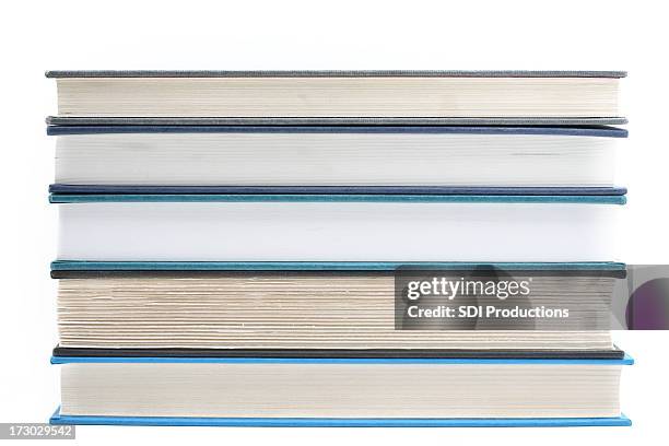 stacked books isolated on white background - van de zijkant stockfoto's en -beelden