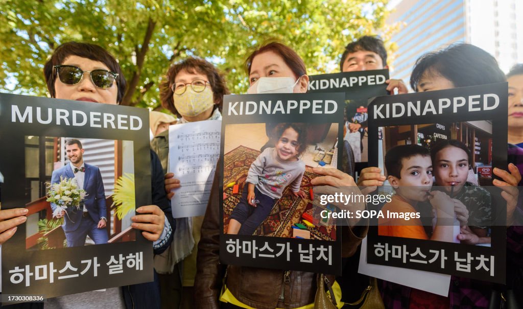 Protesters hold pictures of their murdered and kidnapped...