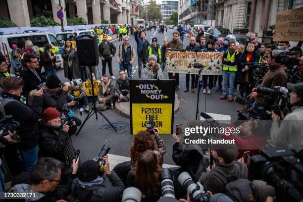 In this handout image provided by Greenpeace, Greta Thunberg speaks to the press as she joins activists from a variety of groups, including...