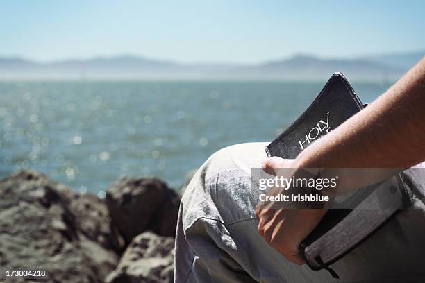 holding a bible - fundamentalism stock pictures, royalty-free photos & images