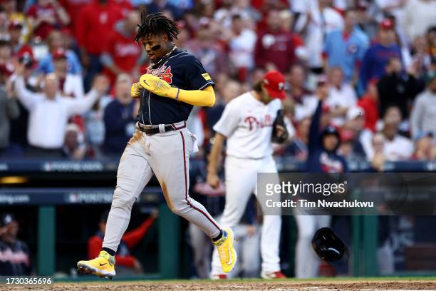 Ronald Acuna Jr. #13 of the Atlanta Braves scores a run off of an RBI single hit by Ozzie Albies against Aaron Nola of the Philadelphia Phillies...