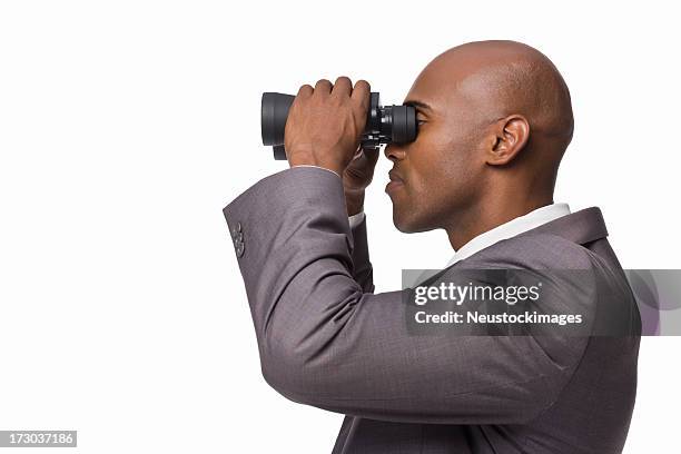 closeup of a young businessman looking through binoculars - binoculars isolated stock pictures, royalty-free photos & images
