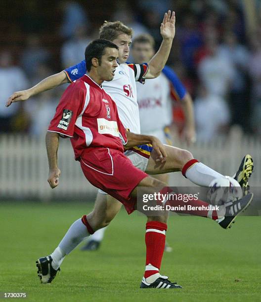 Ante Deur of United is tackled Noel Spencer of the Spirit during the NSL match between the Northern Spirit and Sydney United at North Sydney Oval in...