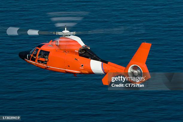 rescue helicopter in action at sea  - coast guard stock pictures, royalty-free photos & images