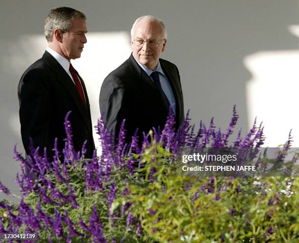 President George W. Bush walks with Vice President Dick Cheney along the colonnade at the White House 29 October 2003 in Washington, DC. Bush is...
