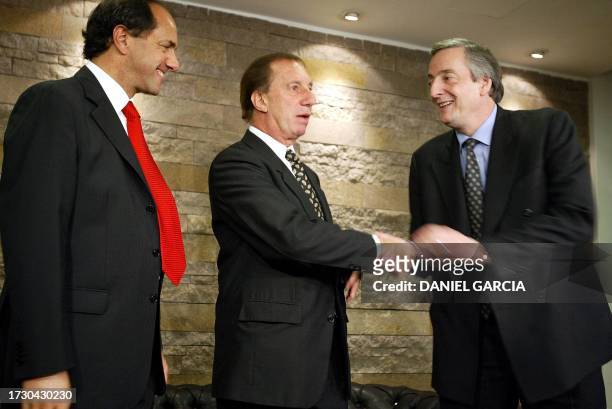 The presidential candidate for the Frente de la Victoria Party, Nestor Kirchner , greets the former coach of the Argentine soccer team, Carlos...