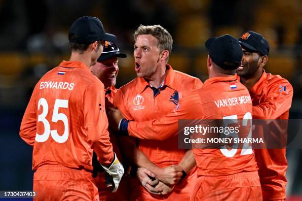 Netherlands' Logan van Beek celebrates with teammates after taking the wicket of South Africa's David Miller during the 2023 ICC Men's Cricket World...
