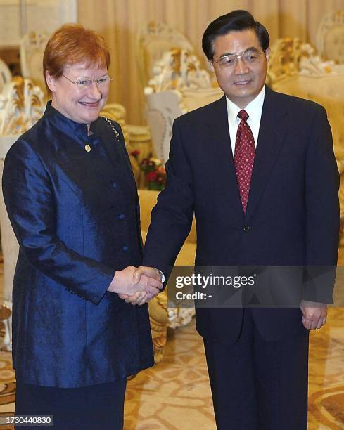 Finnish President Tarja Halonen shakes hands with new top Chinese leader Hu Jintao, prior to a meeting at the Great Hall of the People in Beijing, 27...