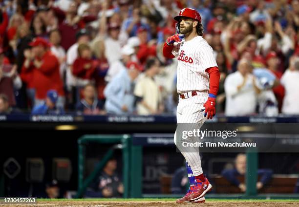 Bryce Harper of the Philadelphia Phillies celebrates after hitting a solo home run against Brad Hand of the Atlanta Braves during the fifth inning in...